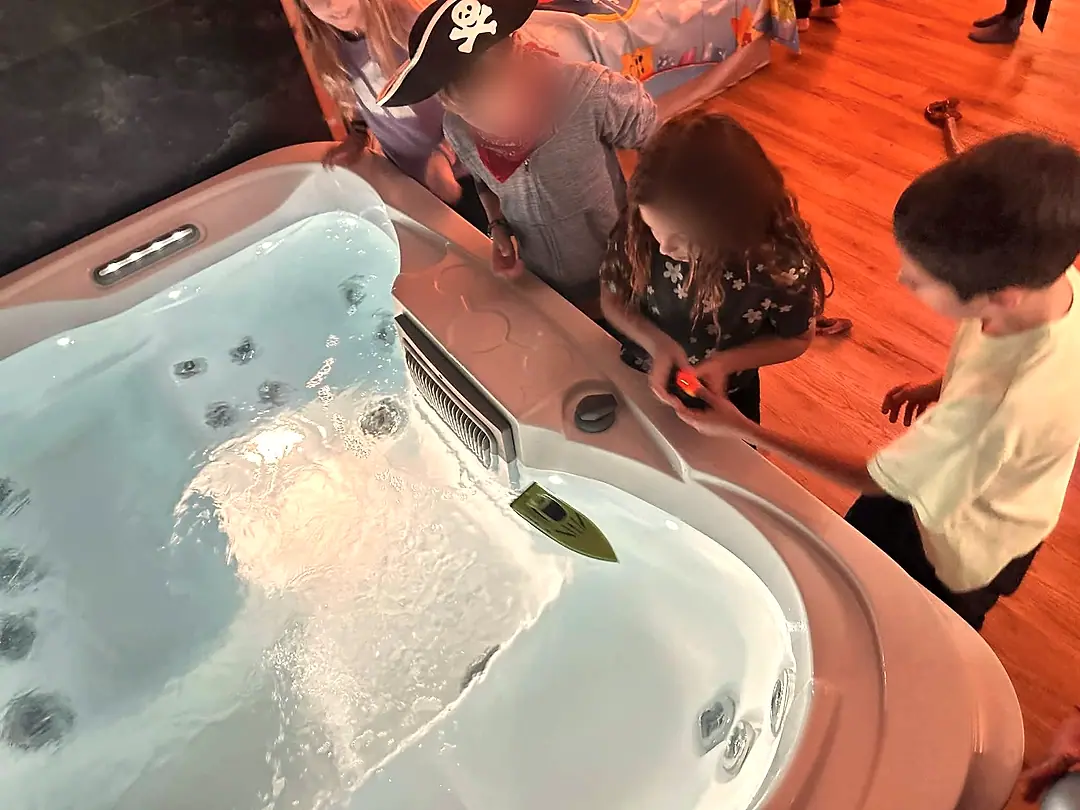 Otroci vodijo ladjice na daljinca po jacuzziju